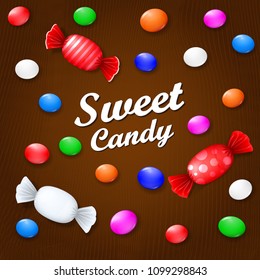 Colored candies, sweets and lollipops. On a brown wooden background. View from above.