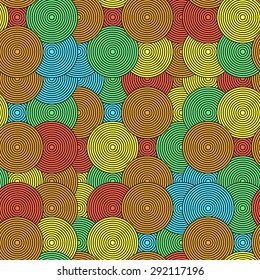 Colored concentric circles. Strewn figures in the form of coils. Seamless vector pattern. Modern background for design of youth sites, posters, postcards. Endlessly repeating background.