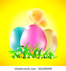 Colored Easter eggs in the grass with a butterfly on a sunny background.
