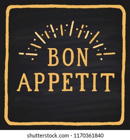 Colored hand-drawn text on a blackboard "bon appetite".