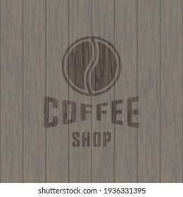 Colored illustration of a grain of coffee, text on a background with a texture of wood. Vector illustration in vintage style for emblem, poster, label, sticker. Coffee shop advertisement.