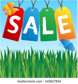 colored labels sales against the blue sky and green grass