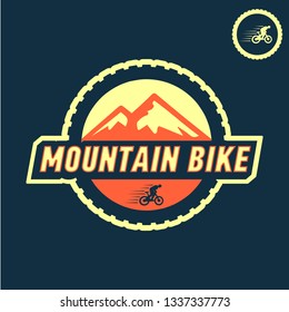 Colored mountain bike vector logo with a picture of a moving cyclist on a mountain background
