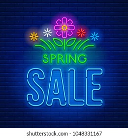 Colored neon light glowing sign Spring Sale with grass and flowers against a brick wall background. Vector illustration.