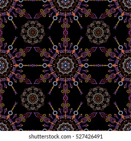 Colored patterns antique. Floral ornament in violet, orange and yellow colors on a black background. Vector seamless background.