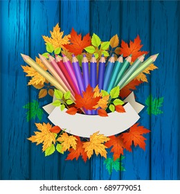 Colored pencils on a wooden texture. Autumn leaves. School. Space for text can be used for  poster or label.Vector illustration