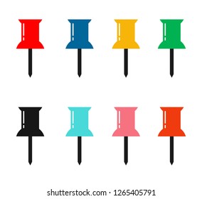 Colored pins and tacks on white background.