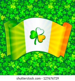 Colored shining celtic clover on Irish flag on green clovers seamless background