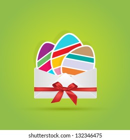 Colored sliced eggs in white envelope with red bow