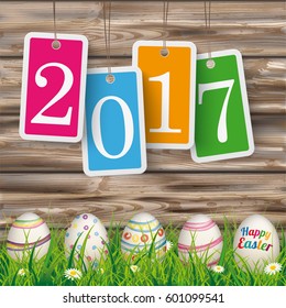 Colored stickers with text 2017 on the wooden background.  Eps 10 vector file.