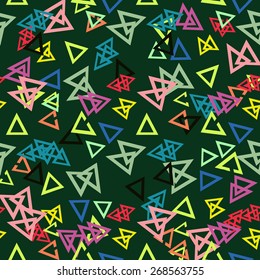 Colored triangles on a green background. Seamless.