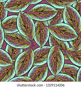 Colored tropical leaves on a pink background. Tropical seamless pattern with exotic leaves.