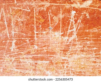 Colored vector grunge texture of cracked, scratched, damaged paint on an orange wall. Unique urban backdrop of a red painted old wall. For overlay, stencil, background, stylization, design