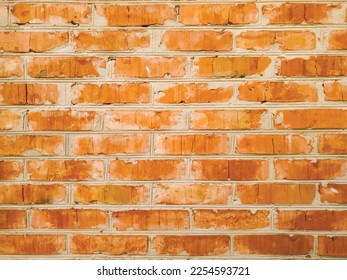 Colored vector texture of an old brick wall. Original illustration of a red brick wall for a designer. Close-up of a wall of carelessly laid bricks