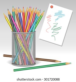 Colored wooden pencils in a metallic glass