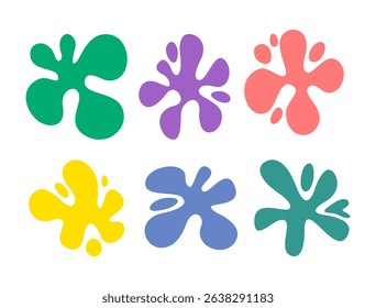 Colorful abstract paint blobs splatter in various organic shapes on a white background, resembling ink splashes or liquid stains in green, purple, red, pinkish, blue, and teal.