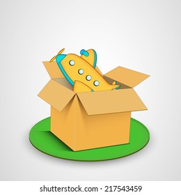 Juguete de avión colorido en caja marrón sobre fondo gris. 