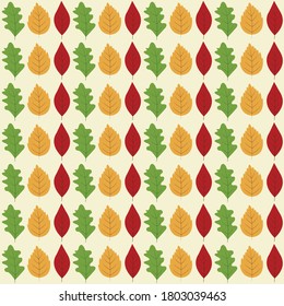 colorful autumn seamless pattern with bright green oak, yellow birch and red ash leaves scattered on light cream background