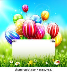 Colorful balloons and empty paper in front of spring landscape