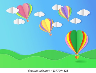 Colorful balloons float in blue sky with cloud on green field. Paper craft vector