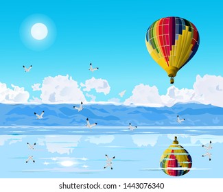 Colorful balloons are floating over the blue sea.Seagulls are flying  with reflections of balloons and birds.Mountains and sky as the background