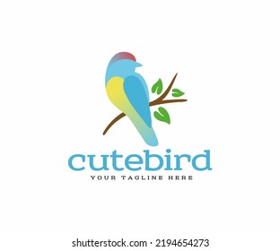 Colorful bird silhouette that sits on a tree branch logo design. Vector design of little bird with beautiful blue, red and yellow feathers. Simple design of tit, nightingale or sparrow bird logotype