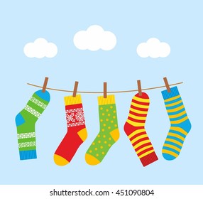 colorful bright socks on a rope with clothespins against a background of sky and clouds. Cute clothes. Cartoon summer illustration.