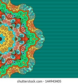 Colorful Card with round floral ornament on turquoise background.