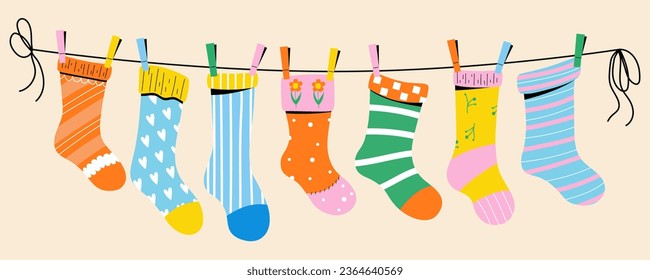 Colorful children socks with textures and patterns drying on the clothesline. Vector illustration