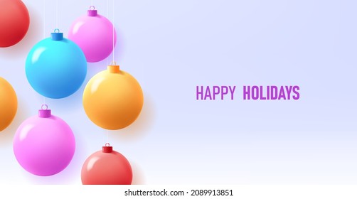 Colorful Christmas balls hanging from top with happy holidays placeholder on light gradient blue