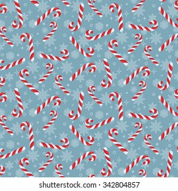 Colorful christmas seamless pattern with twisted spiral striped candy cane on a  blue background with snowflakes