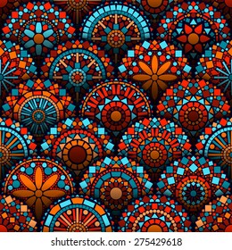 Colorful circle flower mandalas geometric seamless pattern in blue red and orange, vector