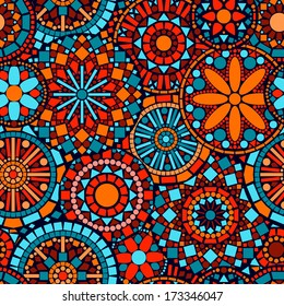 Colorful circle flower mandalas seamless pattern in blue red and orange, vector