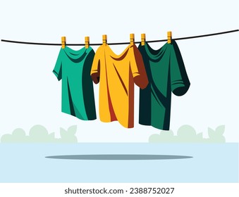 Colorful clothing dries on a clothesline in the yard outside in the sunlight after being washed.