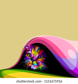 The colorful cute little cat hiding in the blanket
