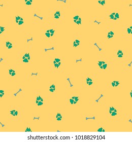 Colorful dog footprint and bone vector seamless pattern. Colored paw bone seamless template, isolated on contrast color background. Drawn silhouette clipart for business purposes or invitation print.