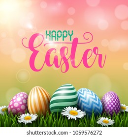 Colorful Easter eggs with daisies flowers on the grass