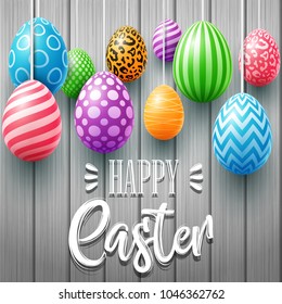 Colorful easter eggs decorated on a wooden background