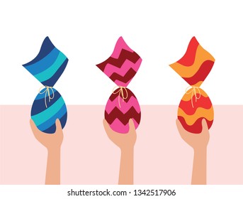 Colorful Easter Eggs. Kids egg hunt. Hands holding three chocolate Eggs wrapped in colorful package. Brazilian Easter egg.