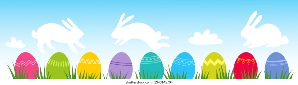 Colorful easter eggs on grass with clouds shaped like Easter bunnies, flat design, horizontal banner with blue sky backdrop