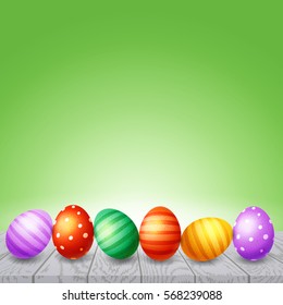 Colorful  Easter eggs on  white wooden board 