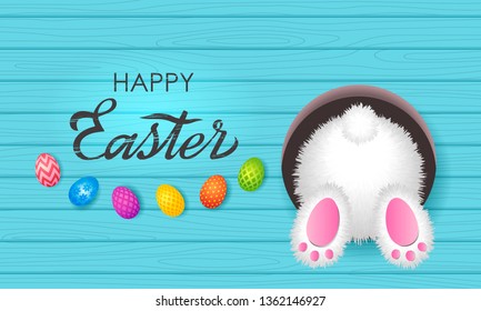 Colorful Easter greeting card. Easter bunny in a burrow with a tail and painted eggs with an ornament on a wooden background with hand-made retro lettering, lettering. vector illustration