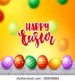 Colorful  eggs  background. Hand drawn calligraphy "happy Easter"   