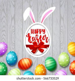 Colorful  eggs with bow and ribbon, bunny white rabbit ears. Hand drawn calligraphy "happy Easter"   