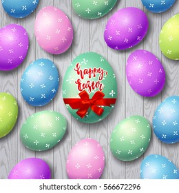 Colorful eggs with bow and ribbon. Hand drawn calligraphy "happy Easter"   