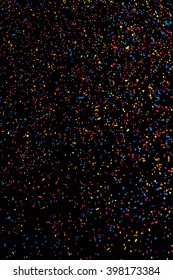Colorful explosion of confetti. Colored stains and blots. Grainy abstract  colorful texture isolated on black background.  Vector illustration,eps 10.