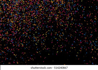 Colorful explosion of confetti. Grainy abstract  multicolored texture isolated on black background. Flat design element. Vector illustration,eps 10.