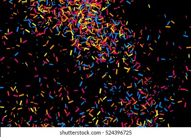 Colorful explosion of confetti. Grainy abstract  multicolored texture isolated on black background. Flat design element. Vector illustration,eps 10.