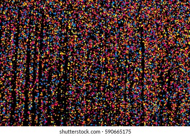 Colorful explosion of confetti. Grainy abstract  multicolored texture isolated on black background. Flat design element. Vector illustration,eps 10.