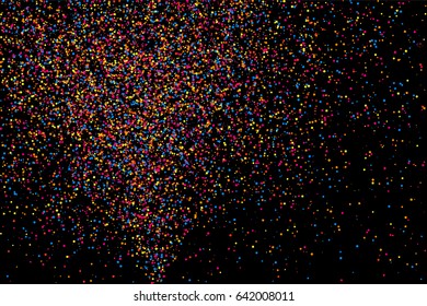Colorful explosion of confetti. Grainy abstract  multicolored texture isolated on black background. Flat design element. Vector illustration,eps 10.